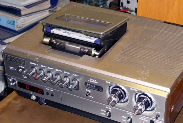 A picture of a device with late 1970s styling that appears to be a top-loading 3.5" floppy drive, with loads of manual settings through the front panel switches.