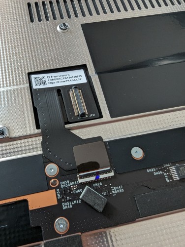 a zoomed in photo of the underside of the framework laptop 16 midplate, specifically the flex cable connecting it to the mainboard

you can notice that the part of the cable going to the midplate is detachable