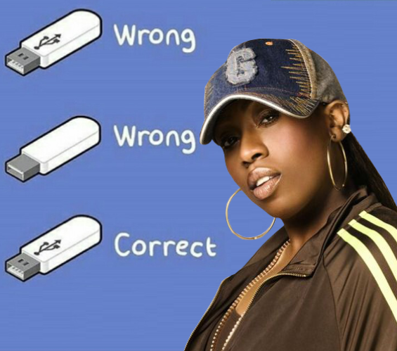 Still image. Cartoon of a USB drive and text. 

Right side up USB drive > Wrong
Flipped over USB drive > Wrong
Flipped over again USB drive > Correct

An image of Missy Elliot dominates the entire right half of the image. 