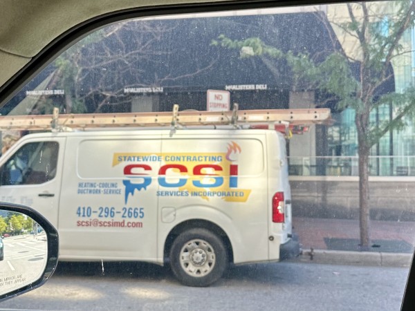A photo taken through a car window of a work van for a Maryland HVAC company named SCSI.