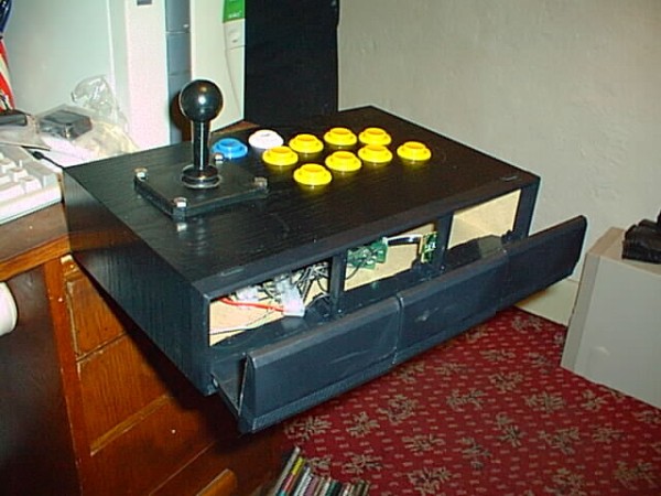 the same crude joystick, but with its cassette drawers open so you can see the wiring stuffed inside