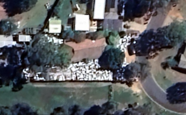 Satellite view of a suburban house completely surrounded by little white rectangles.