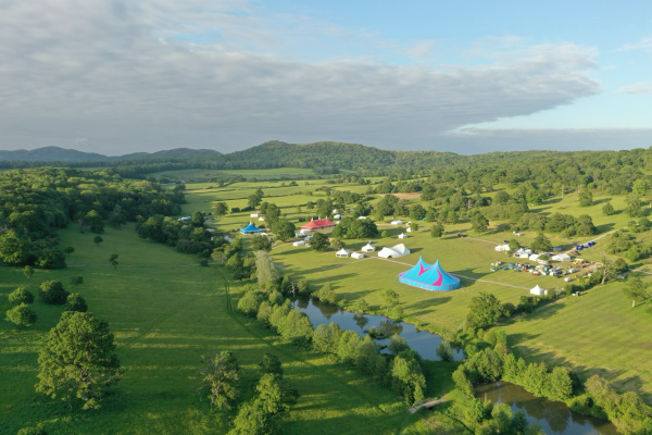 Drone photograph of a field containing tents