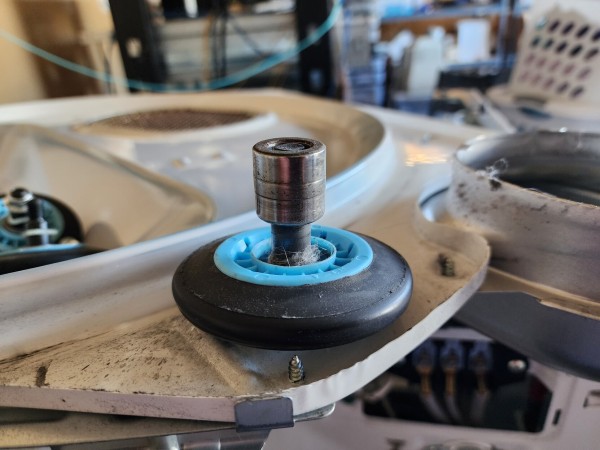 A roller wheel on a bolt. Somehow the inner bearing has slid up so it covers the bolt, completely outside the wheel portion 