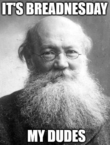 Still image. Pyotr Kropotkin, a person with a large beard and small glasses wearing a slight smile. 

Top text: IT'S BREADNESDAY
Bottomtext: MY DUDES