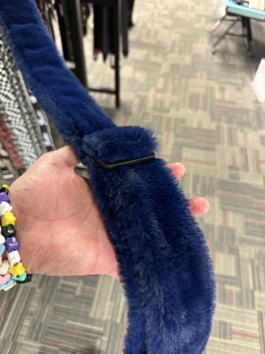 A guitar strap made out of thick blue fur. It looks like Cookie Monster. 