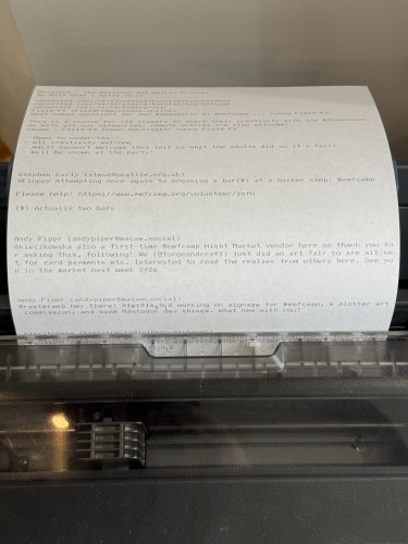 A print out halfway through a dot matrix printer showing toots about #emfcamp