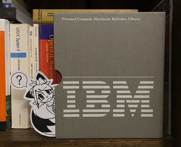 cutout of a sketch of my fursona, peeking out of an IBM PC AT reference binder sleeve