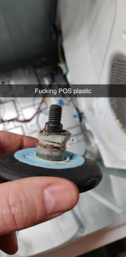 A photograph of a white fingers holding a black rubber wheel with a blue plastic center about a metal bolt. The plastic has melted/sheared off resulting in a failed dryer drum wheel.

There is a snapchat label of "Fucking POS plastic"