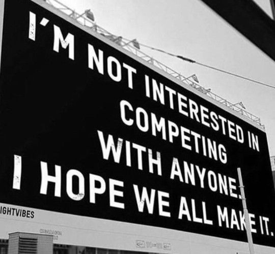 A large sign saying "I'm not interested in competing with anyone. I hope we all make it."