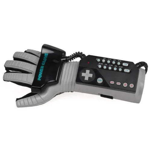 Nintendo Power Glove, which very much looks like an astronaut thing, which given the NASA obsession of the 90's was probably the best marketing ploy ever, in a "space grey" medium-dark grey color with soft flexible plastic backing and small channels breaking up the plastic, about 15 of them per digit, backing a black nylon spandex glove, with a small but not that small black module with "power glove" written on it mounted on the back of the palm with a very heavily strain-reliefed connector connecting it to a Nintendo joypad looking thing mounted above and extend back from the wrist which is also black but with space grey plus shaped joypad and buttons on it. There are two rows of 12 extra buttons (can't quite read) that probably include select and start and five buttons by the joypad so it plausibly has all of the four NES joypad buttons. Then from that is yet another heavily train reliefed cord going back behind it and vanishing. Overlaied on a plain grey background (bit lighter grey than the space grey backing of the whole thing but very much looks like a studio staged photo or a Photoshop image cutout).