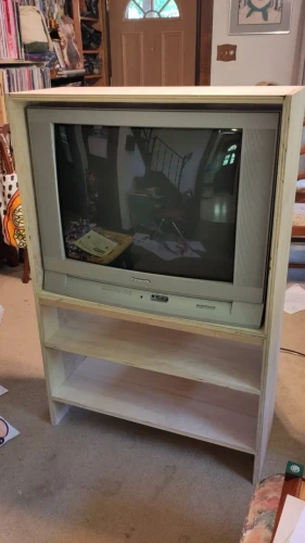 Home-built plywood TV stand containing a 27" CRT TV