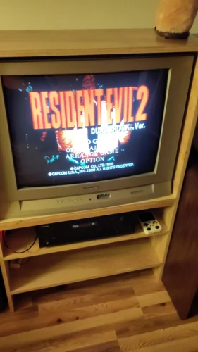 TV is showing Resident Evil 2 title screen