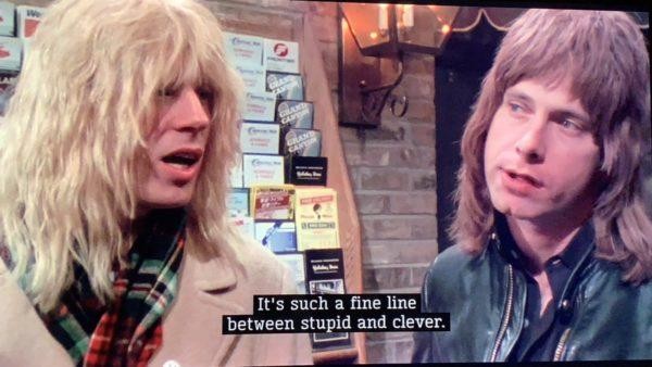 Two guys from Spinal Tap, Nigel Tufnell and the lead singer, who is saying "It's such a fine line between stupid and clever."