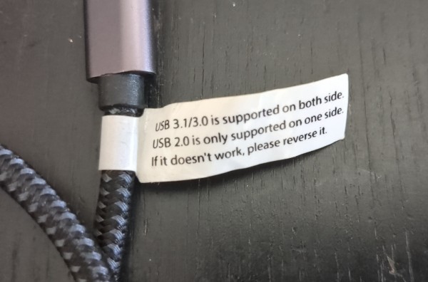 Photograph of a USB-C extension cable. A label is attached to it with text:
USB 3.1/3.0 is supported on both side.
USB 2.0 is only supported on one side.
If it doesn't work, please reverse it.